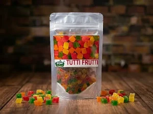 Tutti frutti colorful candied papaya cubes in resealable pouch for baking and desserts